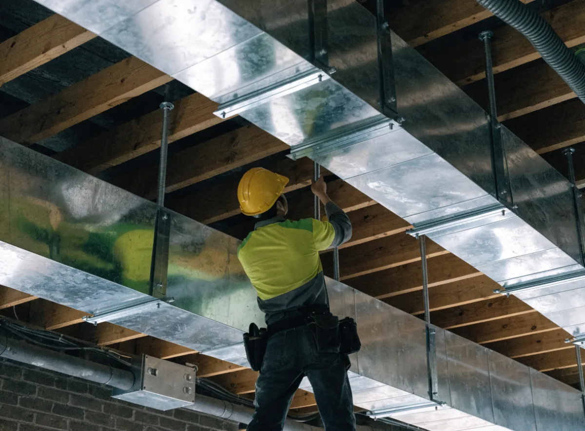 Ductwork being installed in a commercial ceiling space